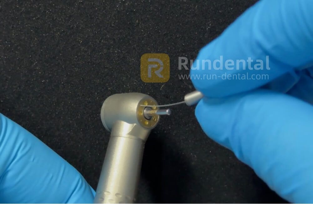Clearing a blocked spray outlet with the original cleaning needle