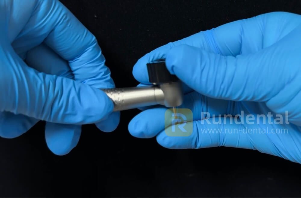Opening the rear cap of a Rundental handpiece with the original wrench