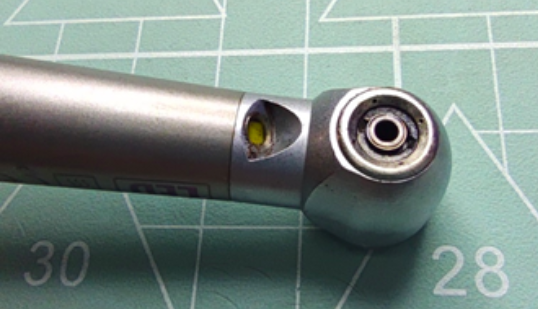 Uncleaned cooling nozzles of a used high speed dental handpiece