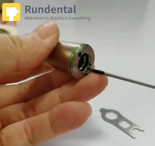 Unscrew the long screw of implant contra angle