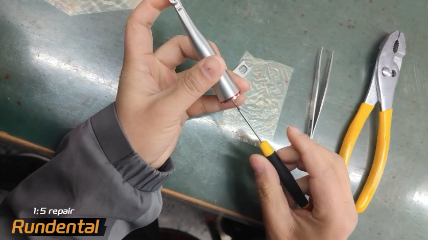 Use a thin screwdriver to unscrew the long screws inside.